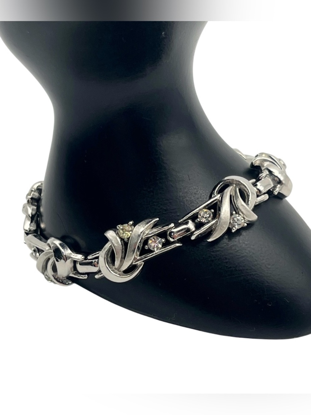 Crown Trifari silver tone bow swirl design silver tone clear rhinestone bracelet